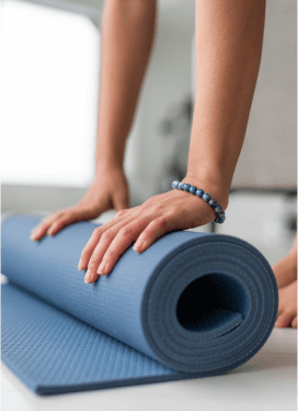 a person rolling up a yoga mat